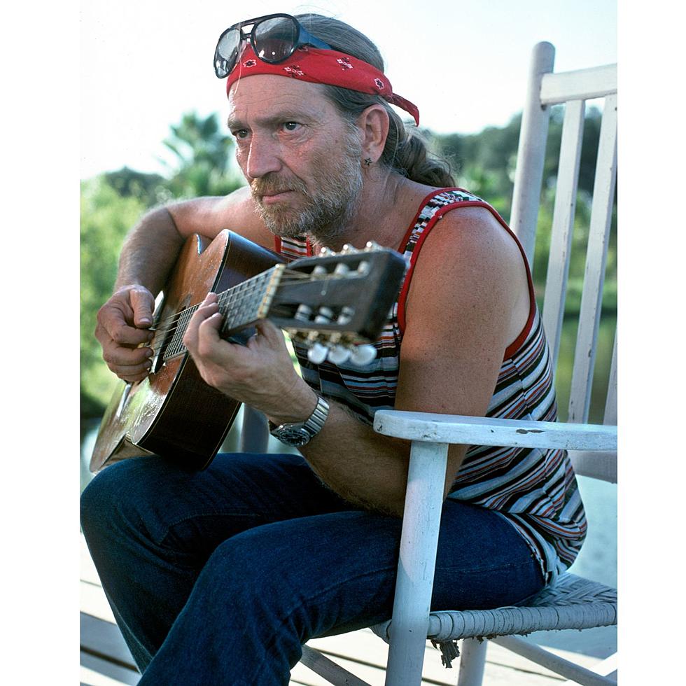 Willie Nelson playing a guitar in 1978
