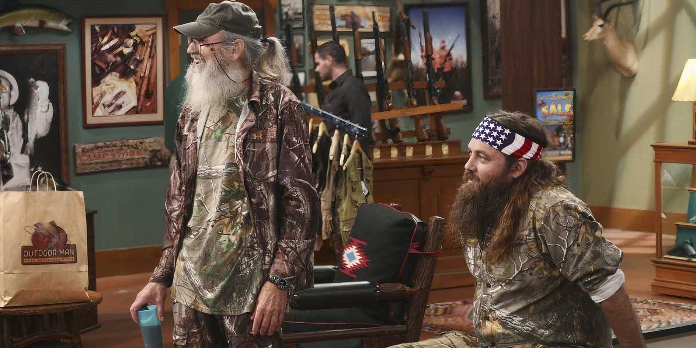 Phil and Willie Robertson smiling and laughing at something in Duck Dynasty.